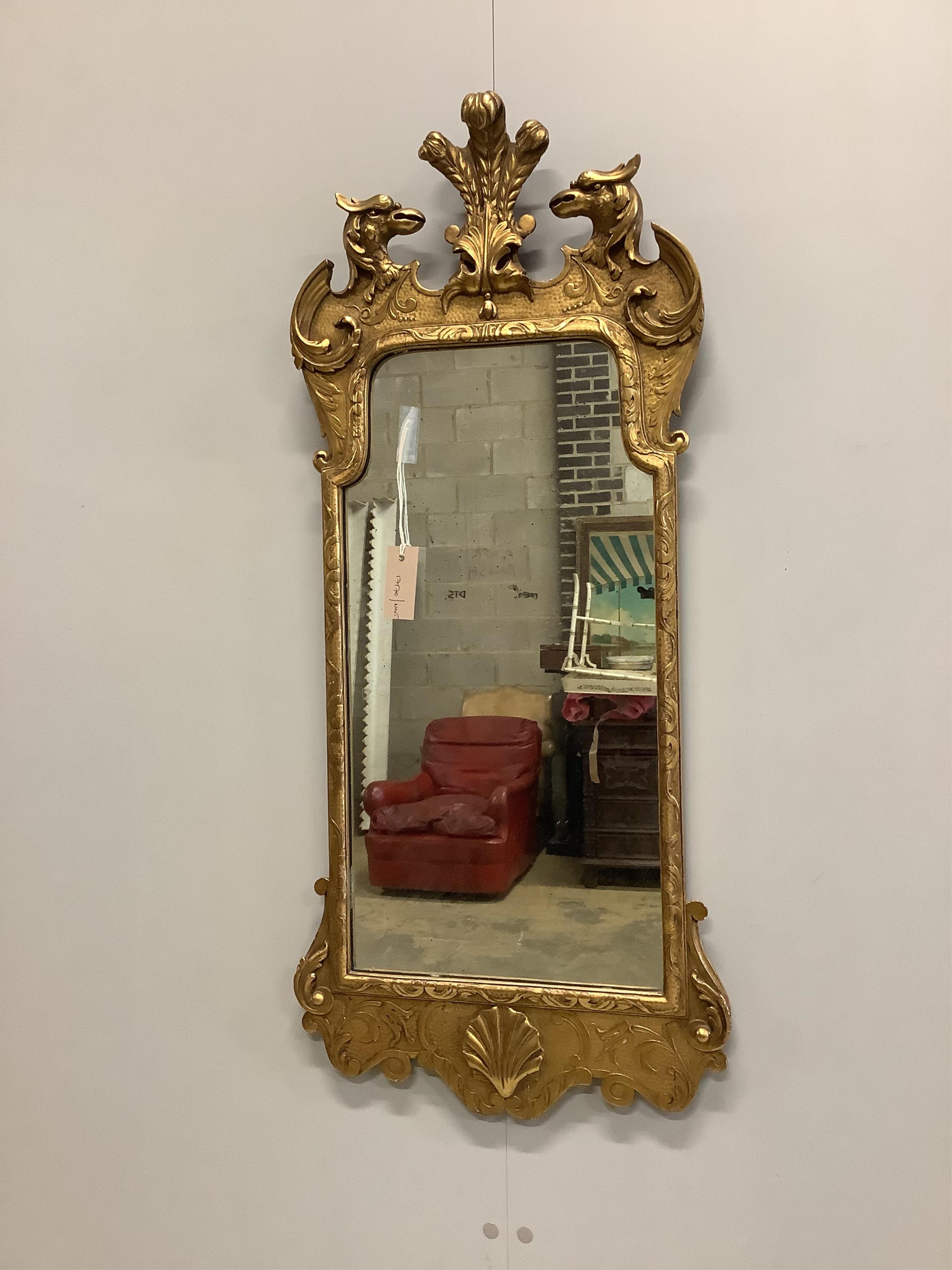 A George II style carved giltwood wall mirror with eagle surmount, width 40cm, 96cm high. Condition - good